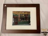 Framed photograph of Shakespeare and Company store front, signed by artist, approx 19x15 inches