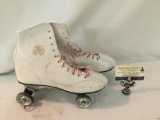 Pair of Official Roller Derby roller skates in white. Size unknown. They measure approximately