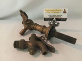 Pair of pipe faucets brass and copper respectively. The large copper piece measures approximately