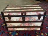 Vintage travel trunk with flower shelf paper covering, approx 34x18x22 inches.