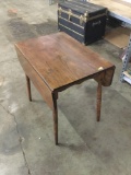 Vintage drop leaf table. Wear and tear. Measures approximately 43x32x30 inches.
