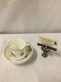 Alice in Wonderland teacup and saucer decorated with images from the story. Approx 5.25x5.25x3.25