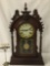 Antique time strike mantle clock with unique molding, floral design glass front & has pendulum/key