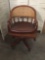 Vintage rattan back office chair with wood frame and vinyl seats