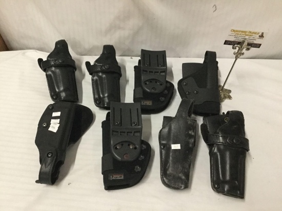 Collection of 8 black leather and canvas pistol holders incl. Uncle Mikes Sidekick, and more