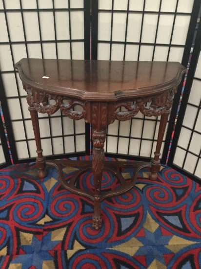 Antique half moon table with a hand carved base & legs feat. a claw foot & lion design