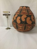 Large earth tone design Native American vase marked Tiqua on the bottom