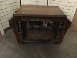 Antique magazine rack side table with ornate carved legs