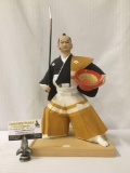 Ceramic Samurai warrior holding a bowl and spear incl. an unattached wooden base
