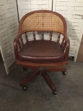Vintage rattan back office chair with wood frame and vinyl seats