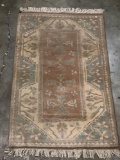Vintage wool rug with fringe in faded neutral tones