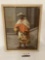 Framed antique canvas painting of a man with baskets, approximately 16 x 21 inches