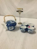 Porcelain tea pot set with 4 cups in a traditional Asian style floral design
