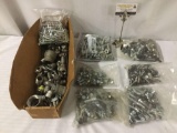 Big lot of bolts, connecters, and pipe pieces. Lot measures approximately 20x12x13.