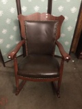 Modern leather and wood rocking chair with stud detail