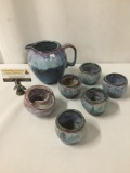 Blue glazed ceramic cups, pitcher, candleholder, and a peculiar bowl, all signed by artist Sievert.