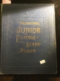The International junior postage stamp album, copyright 1935, w/ hundreds of stamps