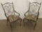 Pair of wrought iron parlor chairs - the upholstery depicts scenes of Urban French life