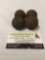 Four antique mini metal cannonballs.