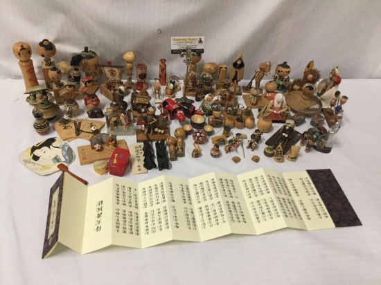 Collection of over 90 collectible Asian wood folk art figures and small collectible display pieces.