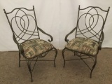 Pair of wrought iron parlor chairs - the upholstery depicts scenes of Urban French life