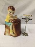 Vintage ceramic cookie jar with boy churning butter design. Made in the USA.
