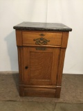 Antique tiger oak cash register cabinet with drawer, brass hardware and granite top