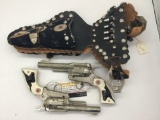 Pair of vintage Hubley Texan Jr die cast cap gun pistols with ornate double holster - tested/working