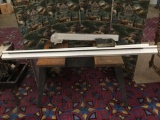 Saw table with attachments. Lot includes two guide rails, an Align A Rip XRC attachment, and two