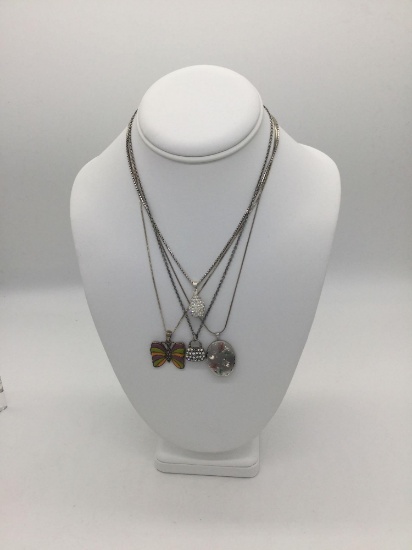 4 sterling silver necklaces with pendants incl. a butterfly pendant, a locket & more