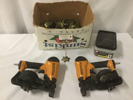Two Bostitch coil roofing nail guns No. 149944, Grip Rite collated framing nails, and a box full of