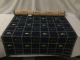 Blue fabric rug roll with fish and bone designs - fabric is over 25 feet unfurled