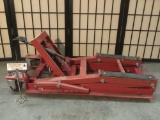 Red hydraulic car or motorcycle jack with casters