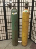 Two vintage oxygen tanks from Airgas and Industrial Air Products