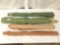 Four rolls of green and brown fabric, approx. 63x7x6 inches.