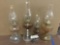 Collection of four Eagle brand Amber tone vintage glass oil lamps.