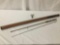 Vintage 7 foot cork handled fishing rod with storage tube, approx. 55x3x3 inches.