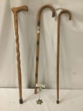 Three sturdy wooden canes, approx. 38x8x1.5 inches.