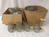 Two boxes full of glass lantern/light fixture globes, approx. 15x15x11 inches.