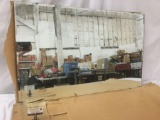 Large wall hanging mirror, a corner of the mirror is missing, approx. 48x30x0.5 inches.
