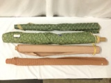 Four rolls of green and brown fabric, approx. 63x7x6 inches.