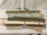 Six rolls of soft and course colorful fabrics, approx. 68x6x6 inches.