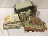 Remnants, arm covers, and other assorted fabrics, approx. 18x14x17 inches.