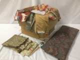 Box full of assorted fabrics, remnants, and upholstery bits. Approx. 20x20x16 inches.
