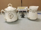 Le Francaise cream and sugar porcelain china set. The cream measures approx 4.5x4.5x4 inches.