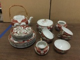 20 piece unmarked china tea service set with gold accents. Some missing lids.