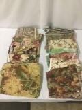 Eleven pieces of floral coarse fabric and upholstery bits, approx. 16x16x12 inches.