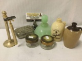 Seven ceramic, metal, glass, and composite small jars, razor, and containers, approx. 4x3x6 inches.