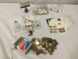 International vintage coins and U.S. stamps, approx. 8x11x3 inches.