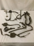 8 pieces of antique leather and metal tree climbing gear, approx. 22x16x7 inches.